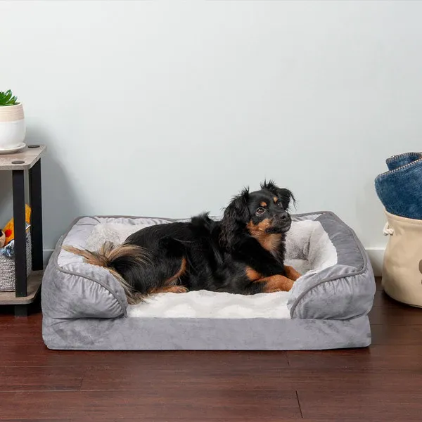 A black and brown long-furred dog relaxing on a FurHaven Velvet Waves Perfect Comfort Bed