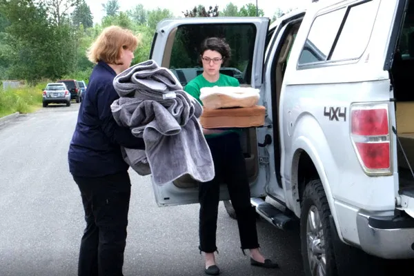 FurHaven employees offloading donations to Whatcom Humane Society from a car